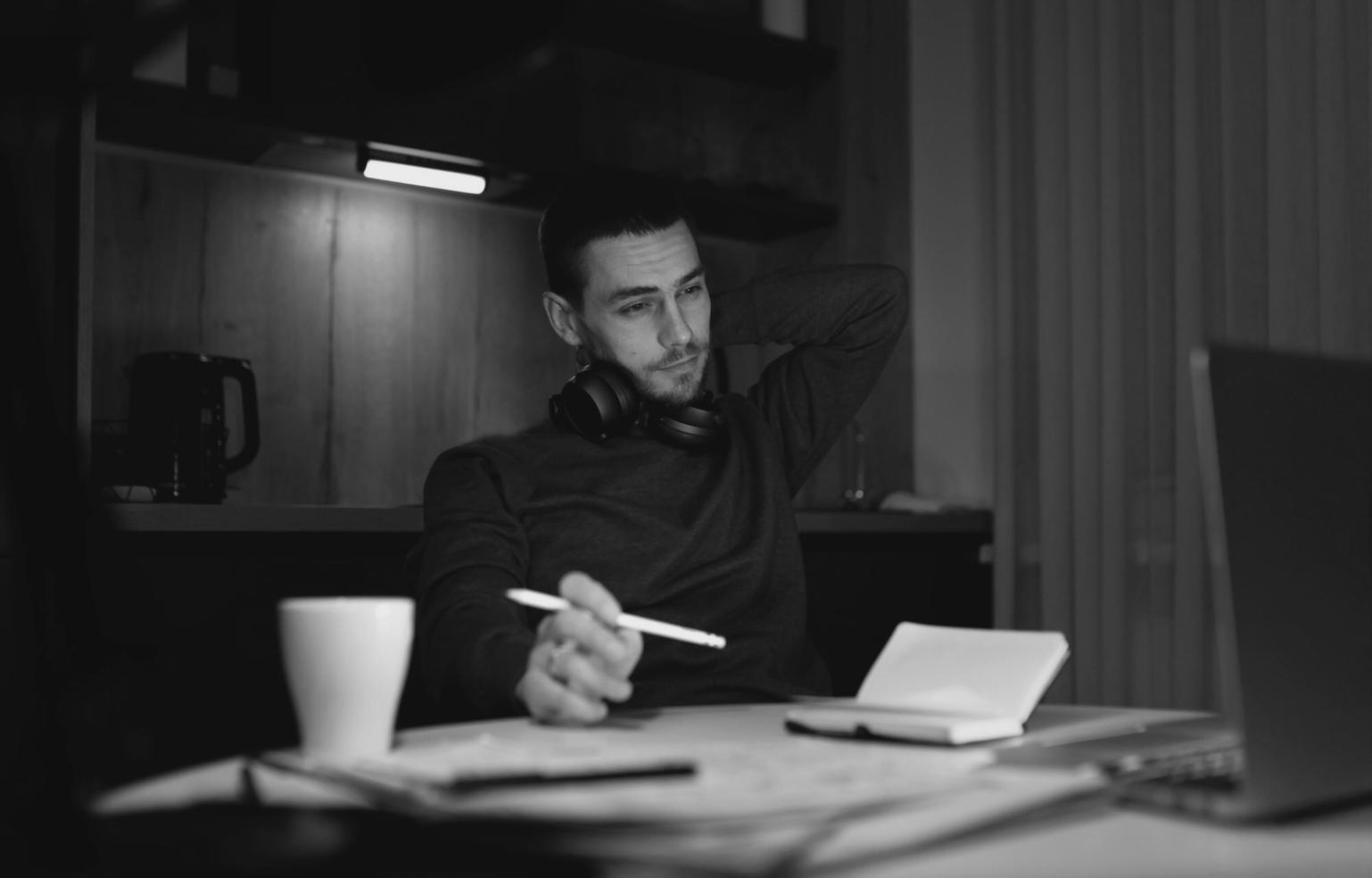 Student reviewing printed financial statements with laptop nearby