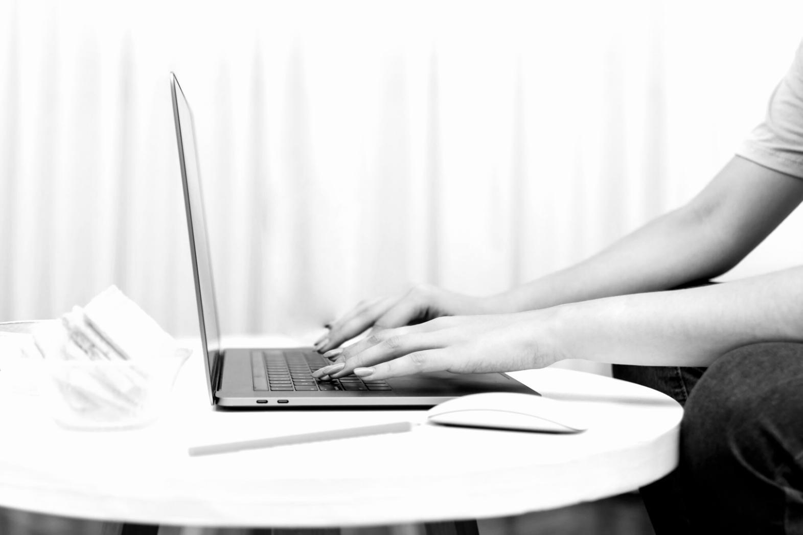 Home office setup with financial charts displayed on computer screens
